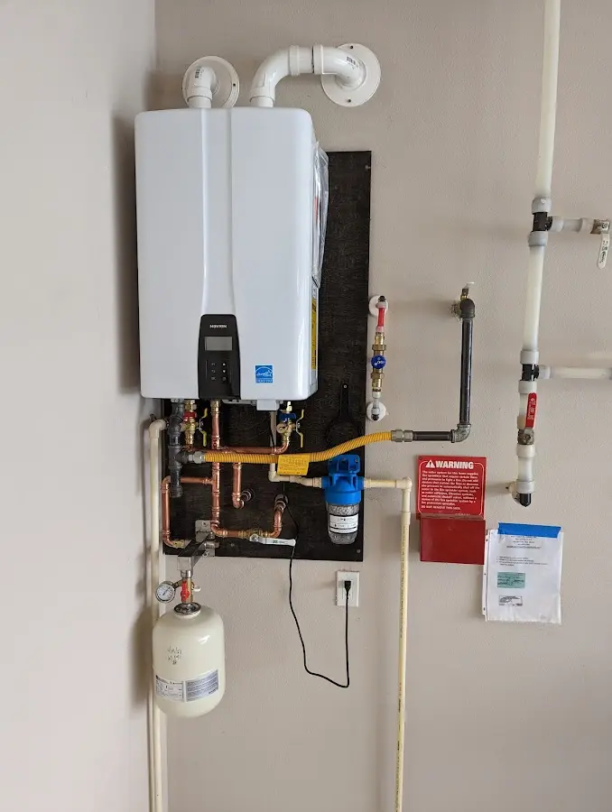Professional plumber installing copper piping in a Earl home